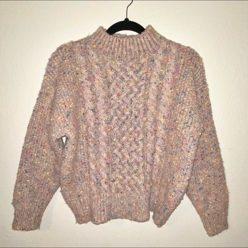 En Creme donegal cable knit mock neck sweater.